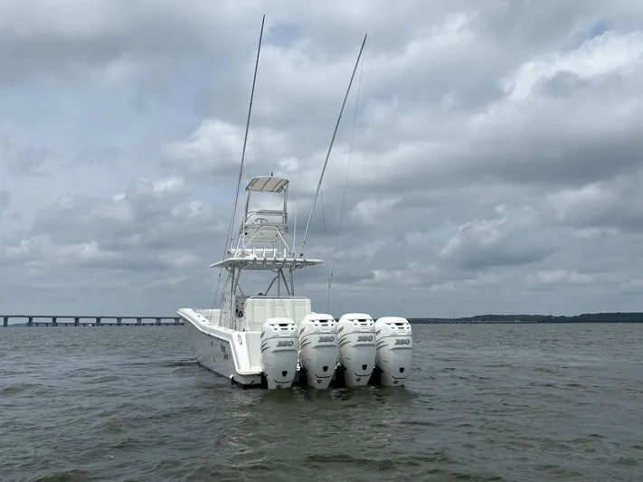 Must Sell!! Yacht Photos Pics 2016 Invincible 42 Open Fisherman boat with four engines on a cloudy day.