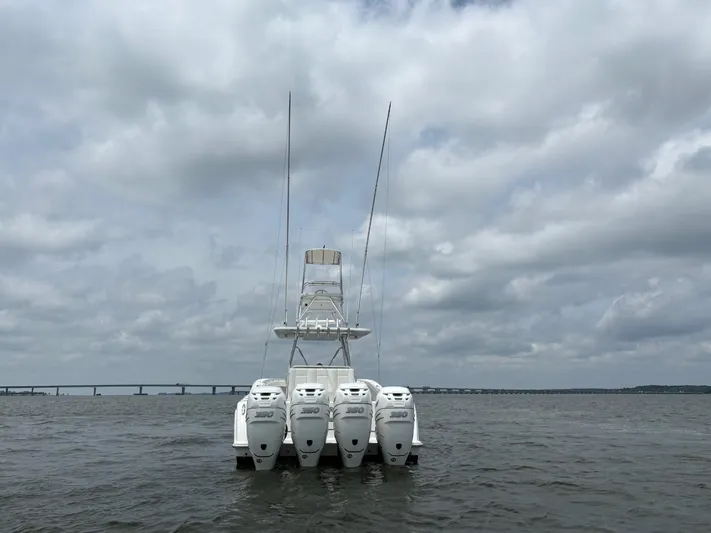 Must Sell!! Yacht Photos Pics 2016 Invincible 42 Open Fisherman with four outboard engines on a cloudy day.