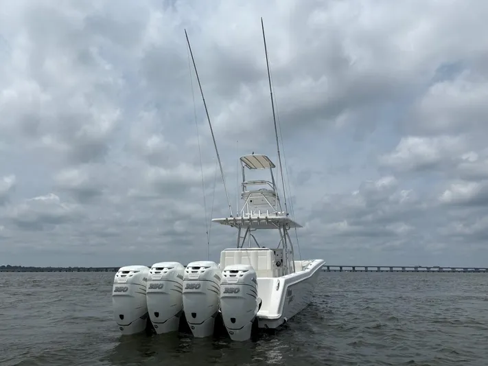 Must Sell!! Yacht Photos Pics 2016 Invincible 42 Open Fisherman boat with four powerful engines on a cloudy day.