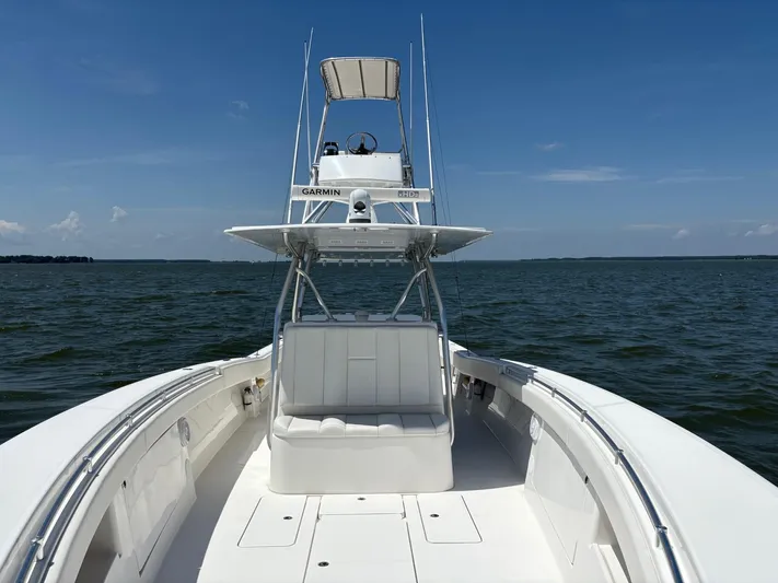 Must Sell!! Yacht Photos Pics 2016 Invincible 42 Open Fisherman boat on open water under clear blue sky.
