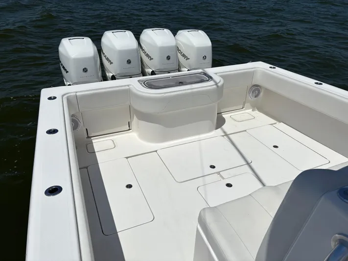 Must Sell!! Yacht Photos Pics 2016 Invincible 42 Open Fisherman boat with four Mercury engines on open water.