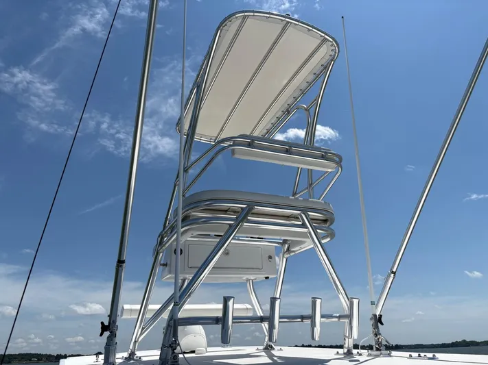 Must Sell!! Yacht Photos Pics 2016 Invincible 42 Open Fisherman boat tower against blue sky.
