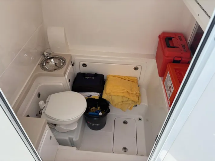 Must Sell!! Yacht Photos Pics 2016 Invincible 42 Open Fisherman boat interior with toilet, sink, and storage items.