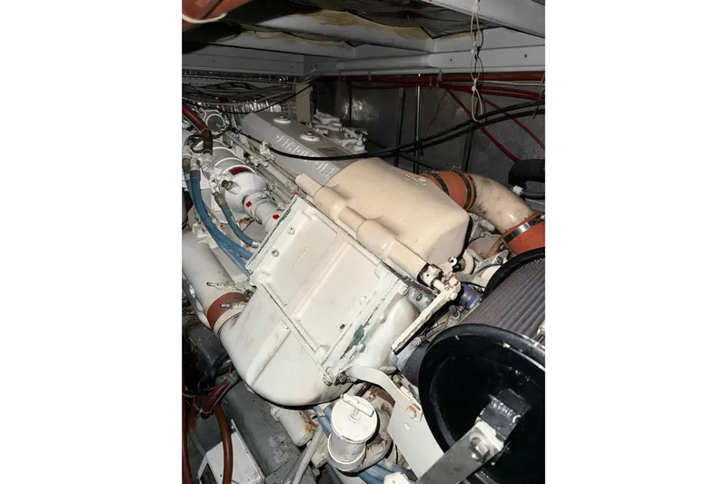  Yacht Photos Pics Engine compartment of a 1989 Silverton 46 Aft Cabin boat, showcasing mechanical components.