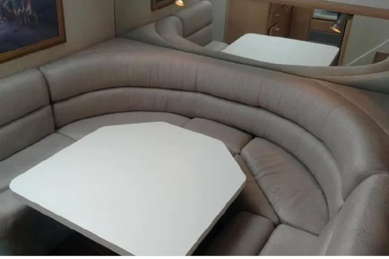  Yacht Photos Pics 1989 Silverton 46 Aft Cabin interior with curved seating and table.