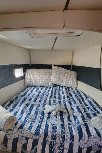 Freedom Yacht Photos Pics Cozy cabin interior of 1993 Lagoon 42 yacht with nautical-themed bedding.