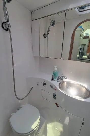 Freedom Yacht Photos Pics Compact bathroom in 1993 Lagoon 42 yacht with shower, sink, and toilet.