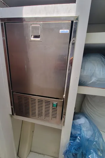 Freedom Yacht Photos Pics Stainless steel appliance on Lagoon 42 yacht, 1993 model, with storage shelves nearby.