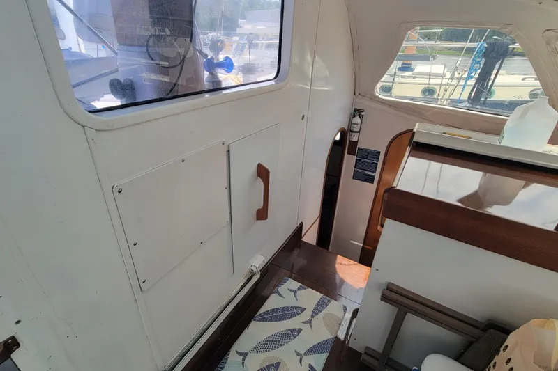 Freedom Yacht Photos Pics Interior view of a 1993 Lagoon 42 sailboat, featuring wooden accents and nautical decor.