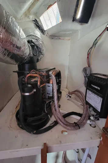 Freedom Yacht Photos Pics Engine room of a 1993 Lagoon 42 yacht, featuring mechanical components and wiring.