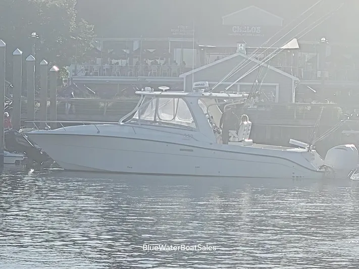  Yacht Photos Pics 2008 Hydra-Sports Vector 3500 VX boat docked near a waterfront restaurant.