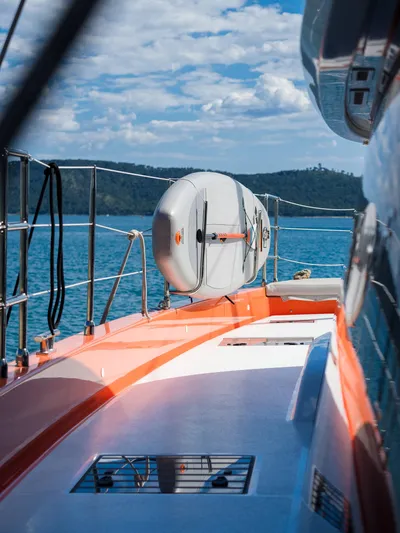 Blessed Yacht Photos Pics 2024 Sunreef 50 A yacht deck with lifebuoy, ocean view, and clear sky.