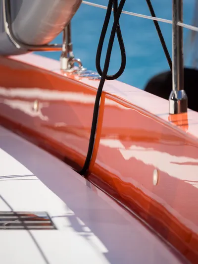 Blessed Yacht Photos Pics 2024 Sunreef 50 A yacht deck with vibrant orange detailing and black rope.