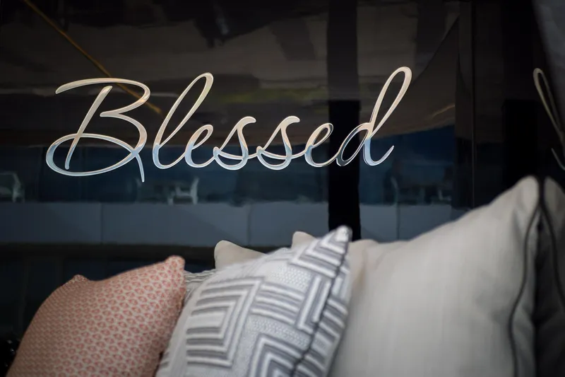Blessed Yacht Photos Pics "Blessed" sign on Sunreef 50 A yacht, 2024 model, with decorative pillows.