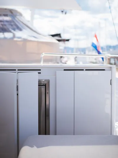 Blessed Yacht Photos Pics 2024 Sunreef 50 A yacht deck with sleek white cabinetry and railing.