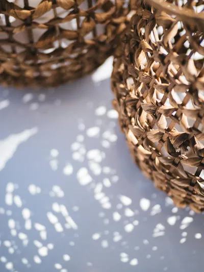 Blessed Yacht Photos Pics Woven basket casting intricate shadows on a surface, Sunreef 50 A, 2024 model.