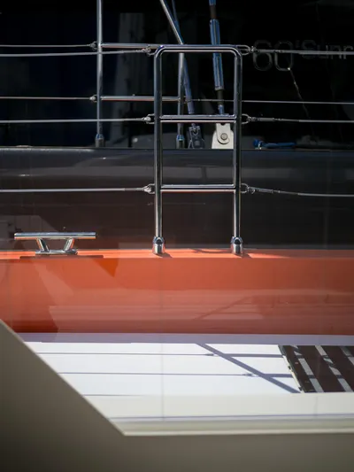 Blessed Yacht Photos Pics 2024 Sunreef 50 A yacht deck with stainless steel railing and orange accents.