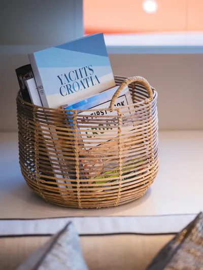 Blessed Yacht Photos Pics Wicker basket with magazines on Sunreef 50 A yacht, 2024 model.
