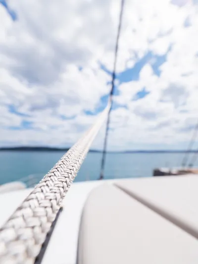 Blessed Yacht Photos Pics Close-up of a rope on a 2024 Sunreef 50 A yacht, with a cloudy sky background.