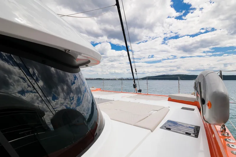 Blessed Yacht Photos Pics 2024 Sunreef 50 A yacht deck with ocean view and cloudy sky reflection.