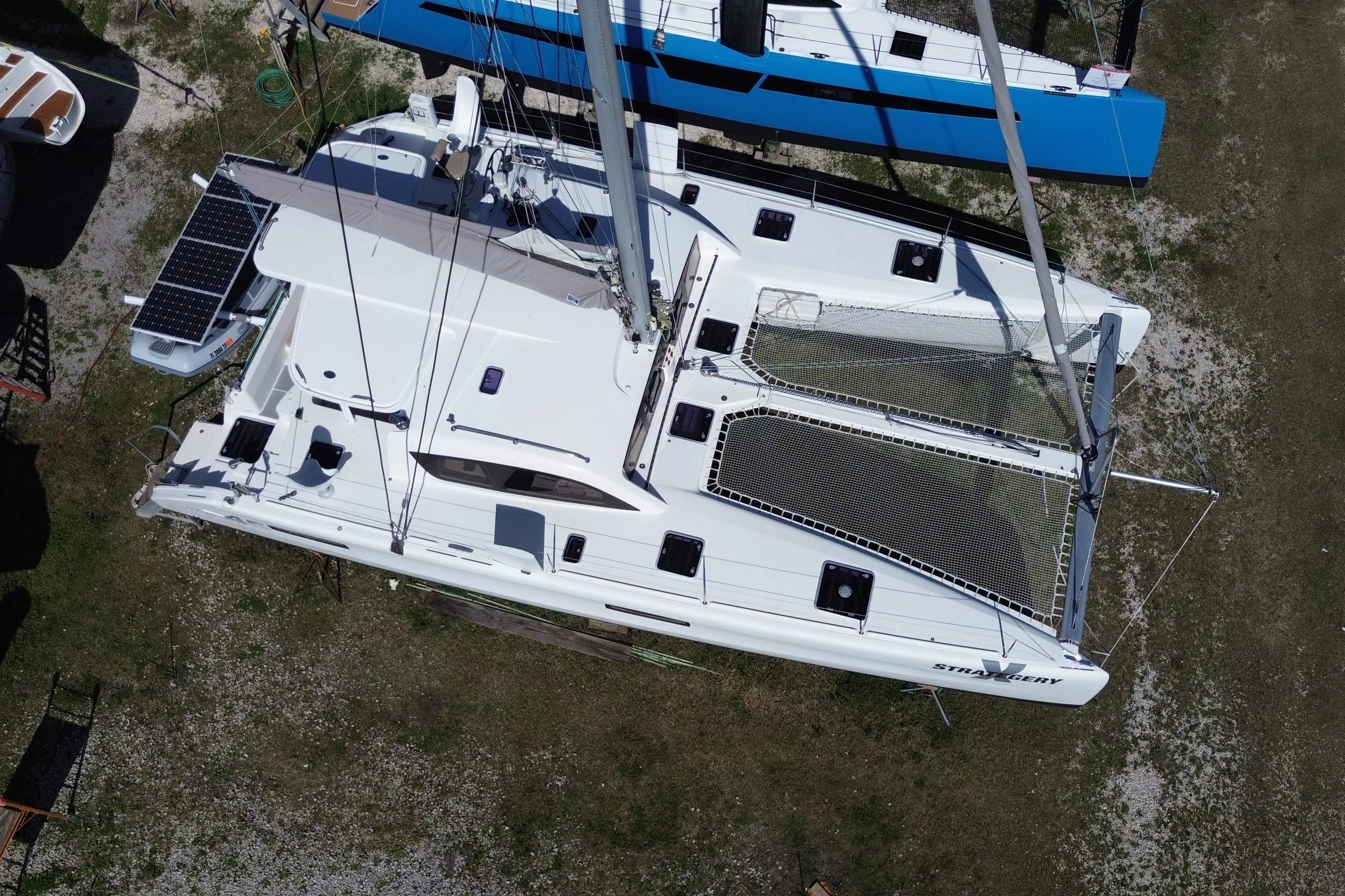 Aerial view of 2014 Outremer 45 catamaran with solar panels and netting on deck.