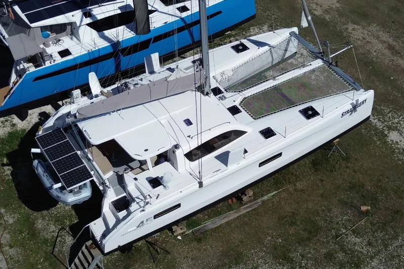 Strategery X Yacht Photos Pics 2014 Outremer 45 catamaran with solar panels, docked on land.