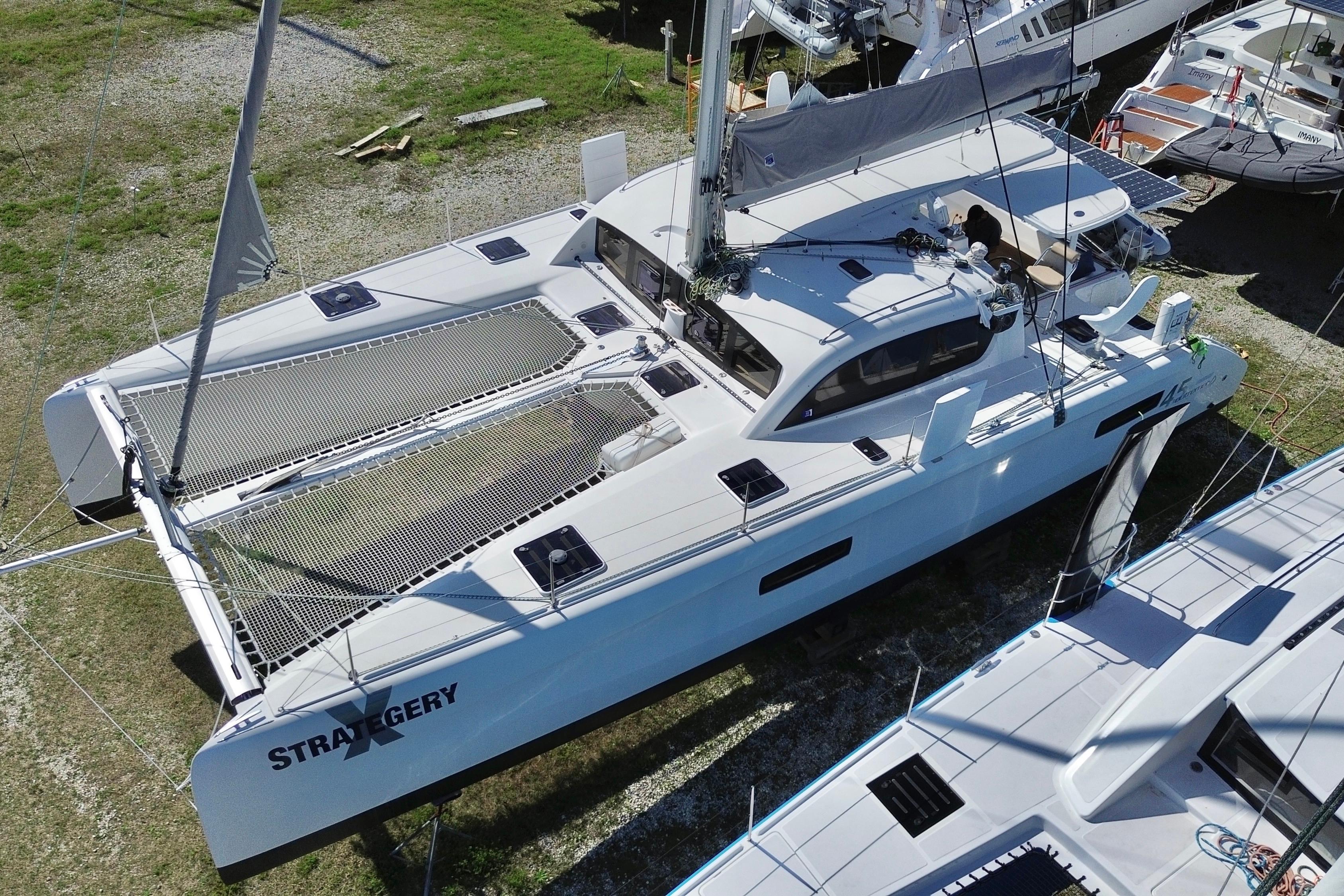 2014 Outremer 45 catamaran on land, showcasing sleek design and spacious deck.