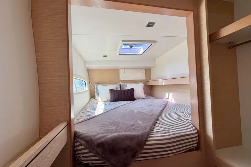 Strategery X Yacht Photos Pics Cozy bedroom interior of 2014 Outremer 45 yacht with striped bedding and skylight.