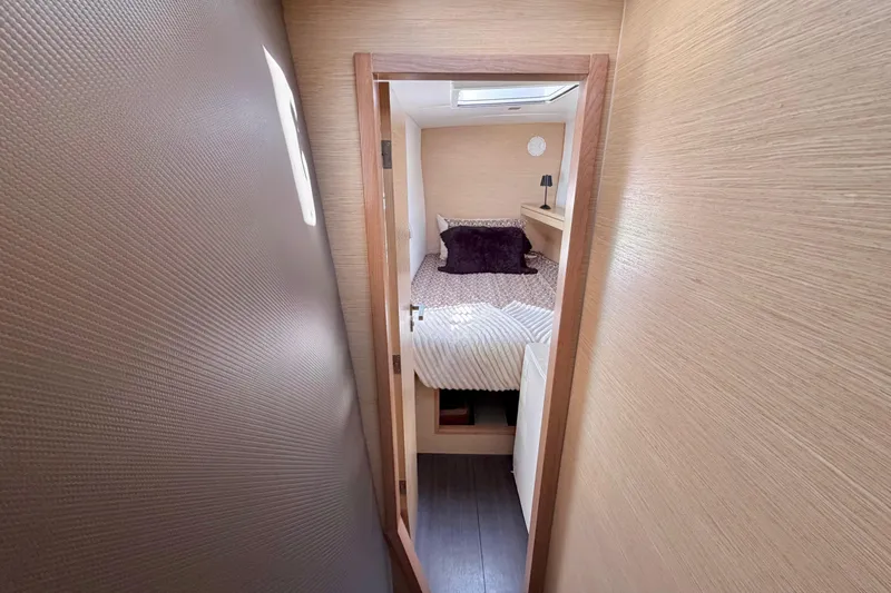 Strategery X Yacht Photos Pics Cozy cabin interior of 2014 Outremer 45 sailboat with bed and soft lighting.