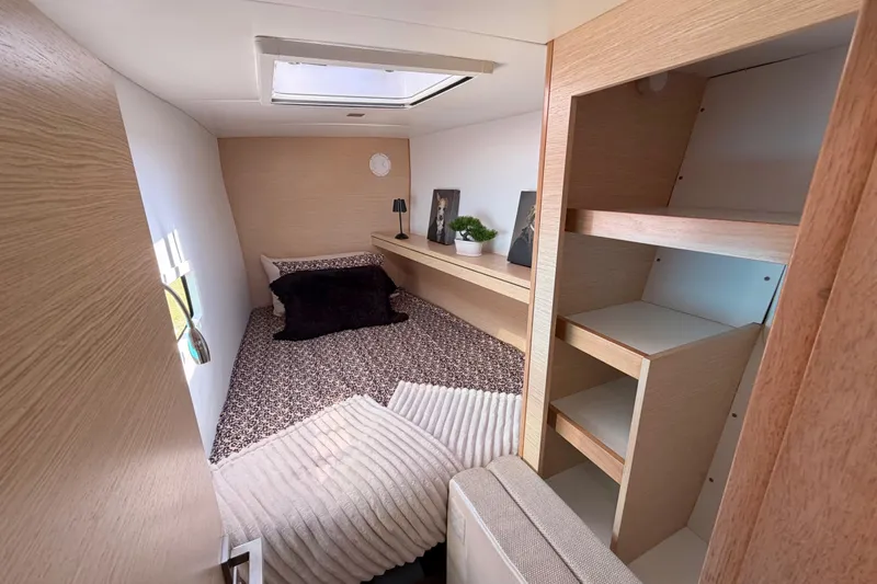 Strategery X Yacht Photos Pics Cozy cabin interior of 2014 Outremer 45 yacht with bed, shelves, and skylight.