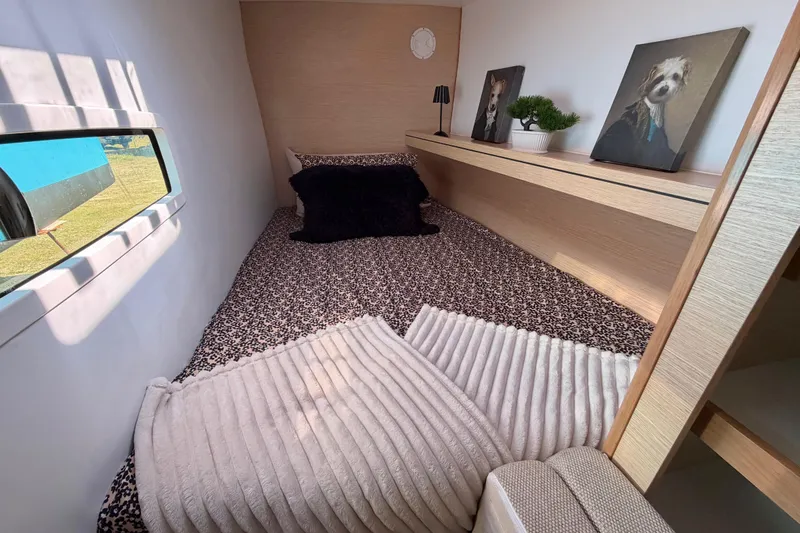 Strategery X Yacht Photos Pics Cozy cabin interior of 2014 Outremer 45 with decorative pillows and artwork.