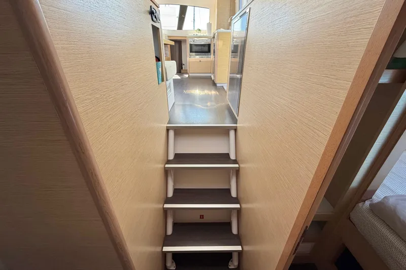 Strategery X Yacht Photos Pics Interior view of 2014 Outremer 45 yacht, featuring stairs leading to the kitchen area.