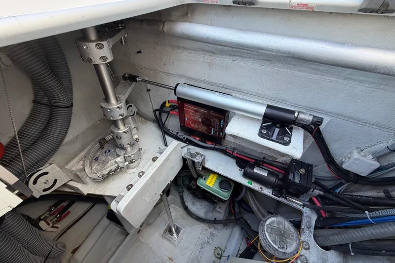 Strategery X Yacht Photos Pics Engine compartment of a 2014 Outremer 45 catamaran, showcasing mechanical components and wiring.