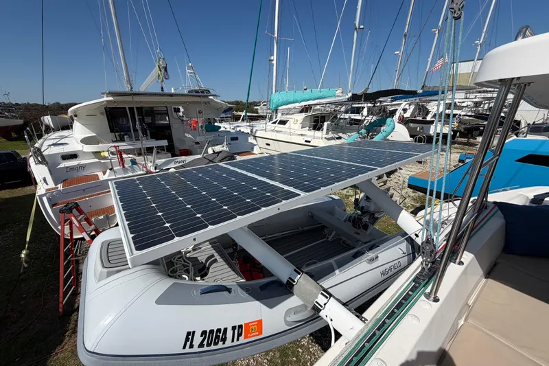 Strategery X Yacht Photos Pics Outremer 45 catamaran with solar panels and inflatable boat, docked in a marina, 2014 model.