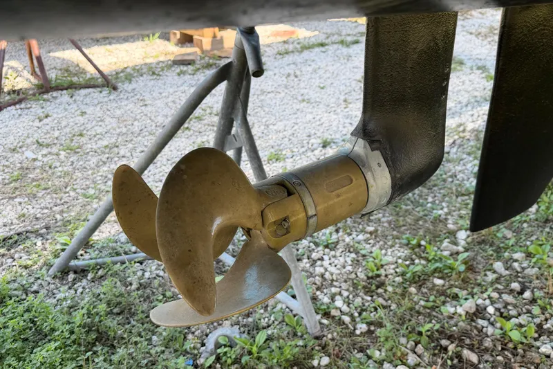 Strategery X Yacht Photos Pics Propeller of a 2014 Outremer 45 catamaran on a gravel surface.