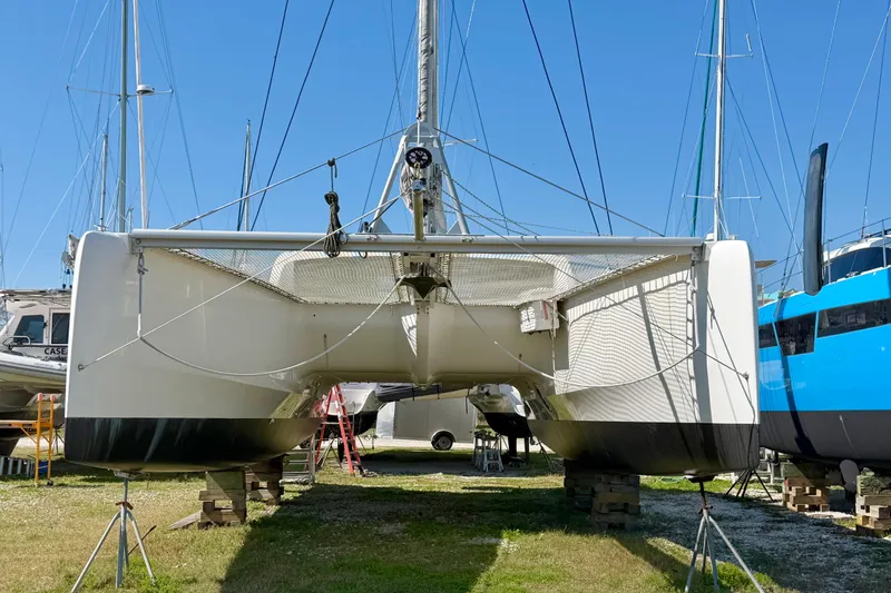 Strategery X Yacht Photos Pics 2014 Outremer 45 catamaran on land, viewed from the front, with clear blue sky.