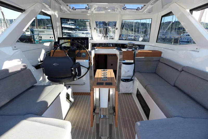  Yacht Photos Pics Luxurious interior of 2020 Amel 60 yacht with modern seating and navigation controls.