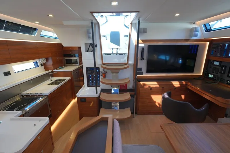  Yacht Photos Pics Luxurious interior of a 2020 Amel 60 yacht featuring modern kitchen and navigation area.