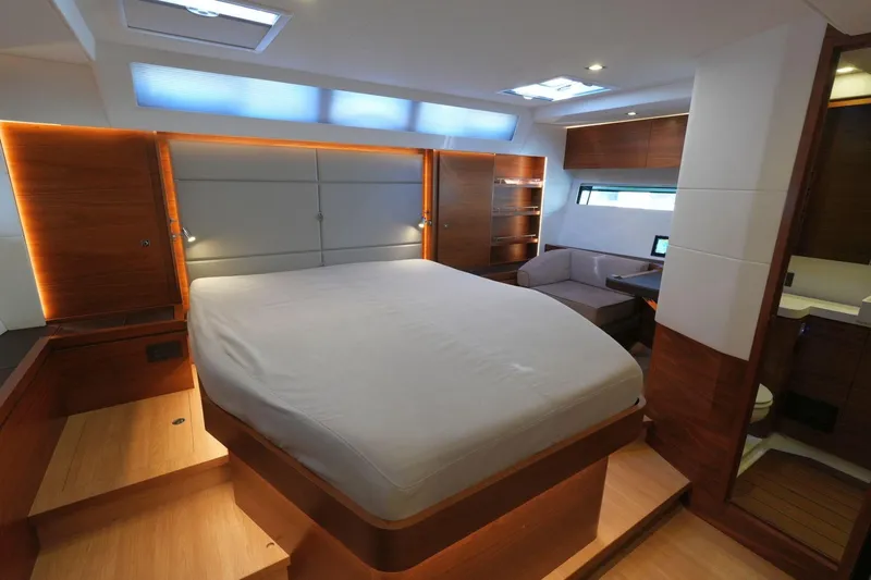  Yacht Photos Pics Luxurious cabin interior of 2020 Amel 60 yacht with modern wood finishes and cozy seating area.