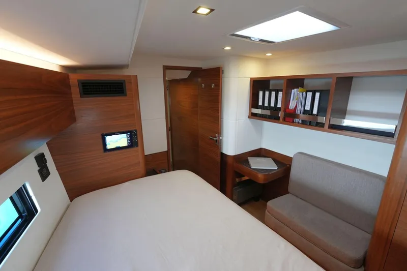  Yacht Photos Pics Luxurious cabin interior of 2020 Amel 60 yacht with modern wood finish and cozy seating.