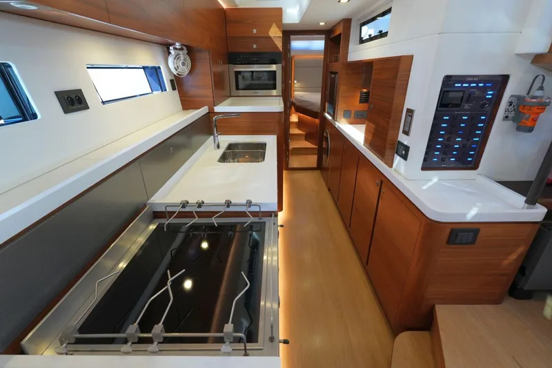  Yacht Photos Pics Luxurious interior of a 2020 Amel 60 yacht, featuring modern kitchen and control panel.