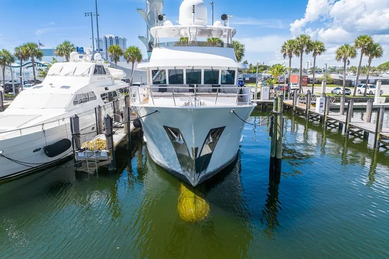  Yacht Photos Pics Luxury yacht ABD 90 Explorer 1996 docked at marina, surrounded by palm trees and clear skies.