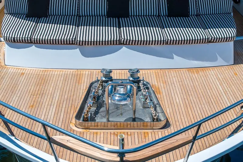  Yacht Photos Pics Luxury yacht deck with striped seating, featuring a 1996 ABD 90 Explorer.