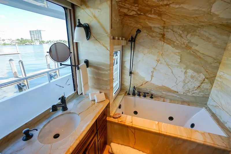  Yacht Photos Pics Luxurious marble bathroom on 1996 ABD 90 Explorer yacht with waterfront view.