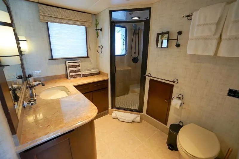  Yacht Photos Pics Luxurious 1996 ABD 90 Explorer yacht bathroom with marble countertop and glass shower.