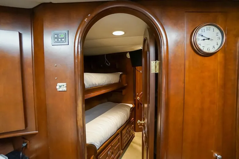  Yacht Photos Pics Interior of 1996 ABD 90 Explorer yacht with wooden bunk beds and clock.