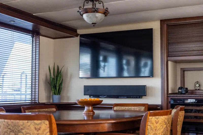  Yacht Photos Pics Luxurious dining area in 1996 ABD 90 Explorer yacht with TV and elegant decor.