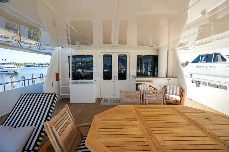  Yacht Photos Pics Spacious deck of 1996 ABD 90 Explorer yacht with wooden furniture and scenic marina view.