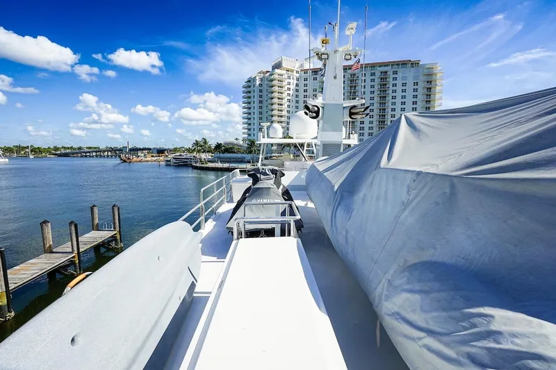  Yacht Photos Pics Luxury yacht ABD 90 Explorer 1996 docked by waterfront buildings under blue sky.
