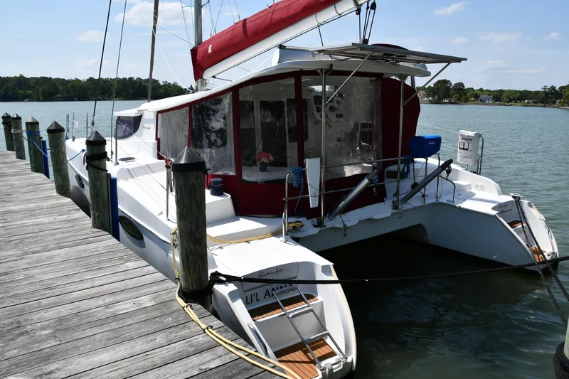 Lil Anna Yacht Photos Pics 2014 Fountaine Pajot Mahe 36 Evolution catamaran docked by a wooden pier.